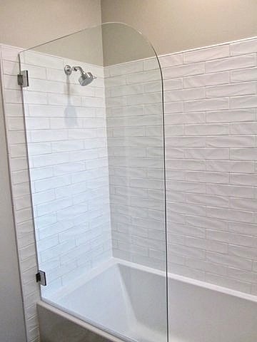 Mid-sized trendy master white tile and porcelain tile ceramic tile bathroom photo in San Francisco with flat-panel cabinets, dark wood cabinets, a one-piece toilet, beige walls, an integrated sink and quartz countertops