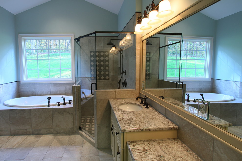 Large elegant master beige tile bathroom photo in Other with an undermount sink, beige cabinets, granite countertops, a two-piece toilet and blue walls