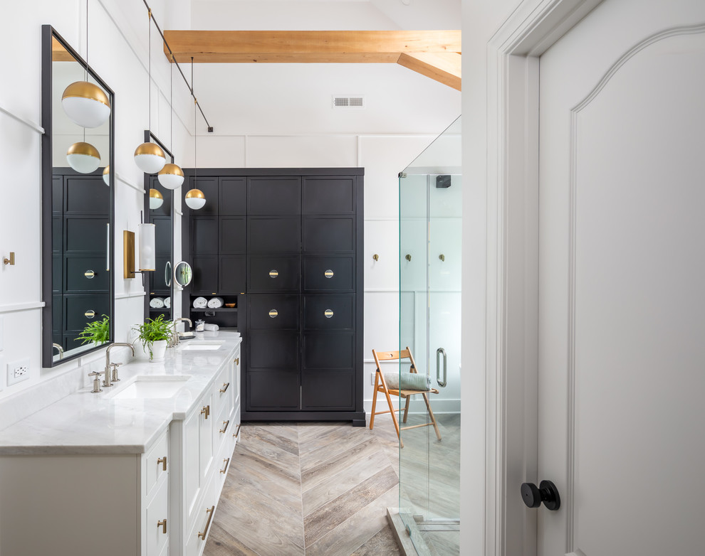 Inspiration for a mid-sized country master white tile and ceramic tile porcelain tile and brown floor bathroom remodel in Raleigh with recessed-panel cabinets, white cabinets, a two-piece toilet, white walls, an undermount sink, marble countertops, a hinged shower door and white countertops