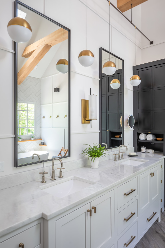 Example of a mid-sized cottage master white tile and ceramic tile porcelain tile and brown floor bathroom design in Raleigh with recessed-panel cabinets, white cabinets, a two-piece toilet, white walls, an undermount sink, marble countertops, a hinged shower door and white countertops