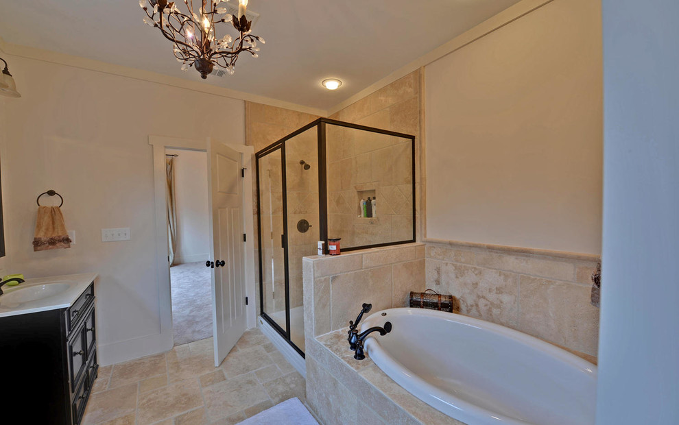 Bathroom - large craftsman master beige tile and travertine tile travertine floor and beige floor bathroom idea in Atlanta with raised-panel cabinets, beige cabinets, beige walls, an integrated sink, granite countertops and a hinged shower door