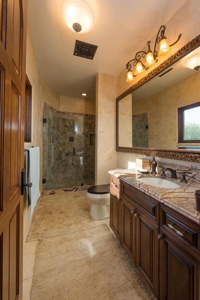 Example of a mid-sized trendy master beige tile, black tile, brown tile, gray tile and stone slab travertine floor bathroom design in Los Angeles with raised-panel cabinets, dark wood cabinets, beige walls, an undermount sink and marble countertops