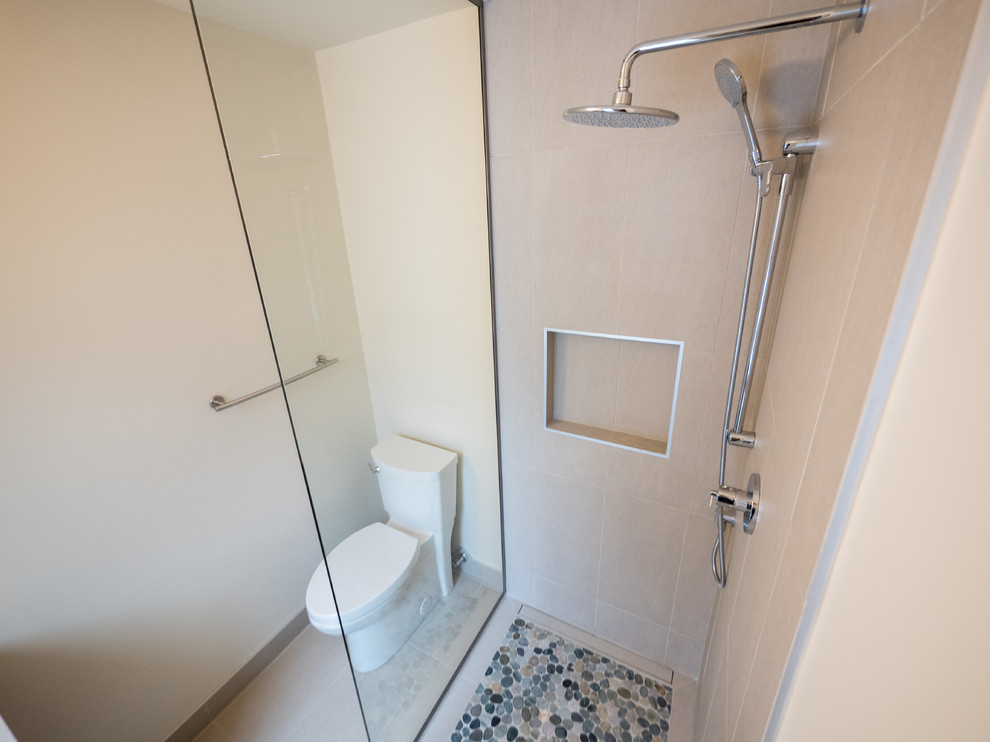 Design ideas for a medium sized contemporary shower room bathroom in Edmonton with flat-panel cabinets, medium wood cabinets, an alcove bath, a shower/bath combination, a two-piece toilet, beige tiles, brown tiles, porcelain tiles, beige walls, porcelain flooring, a submerged sink, engineered stone worktops, brown floors and a shower curtain.