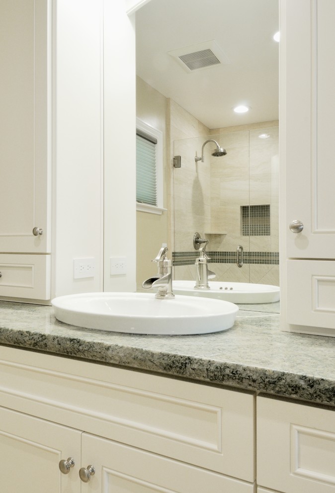 Medium sized classic ensuite bathroom in Sacramento with a built-in sink, recessed-panel cabinets, white cabinets, granite worktops, a built-in bath, a corner shower, white tiles, stone tiles, beige walls and travertine flooring.