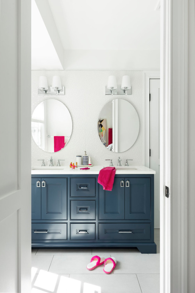Design ideas for a medium sized classic family bathroom in New York with blue cabinets, white tiles, ceramic tiles, white walls, porcelain flooring, a submerged sink, engineered stone worktops, white floors, white worktops, double sinks, a built in vanity unit and recessed-panel cabinets.