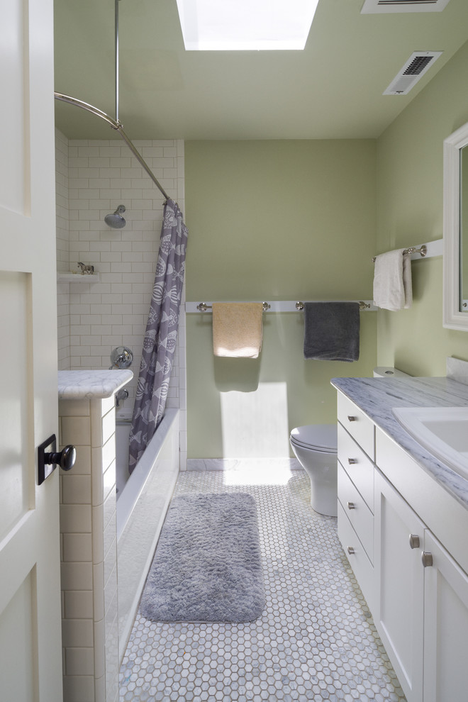 Photo of a traditional bathroom in San Francisco with a shower/bath combination, a two-piece toilet, white tiles, metro tiles, green walls, mosaic tile flooring, a built-in sink, marble worktops, multi-coloured floors, a shower curtain and multi-coloured worktops.