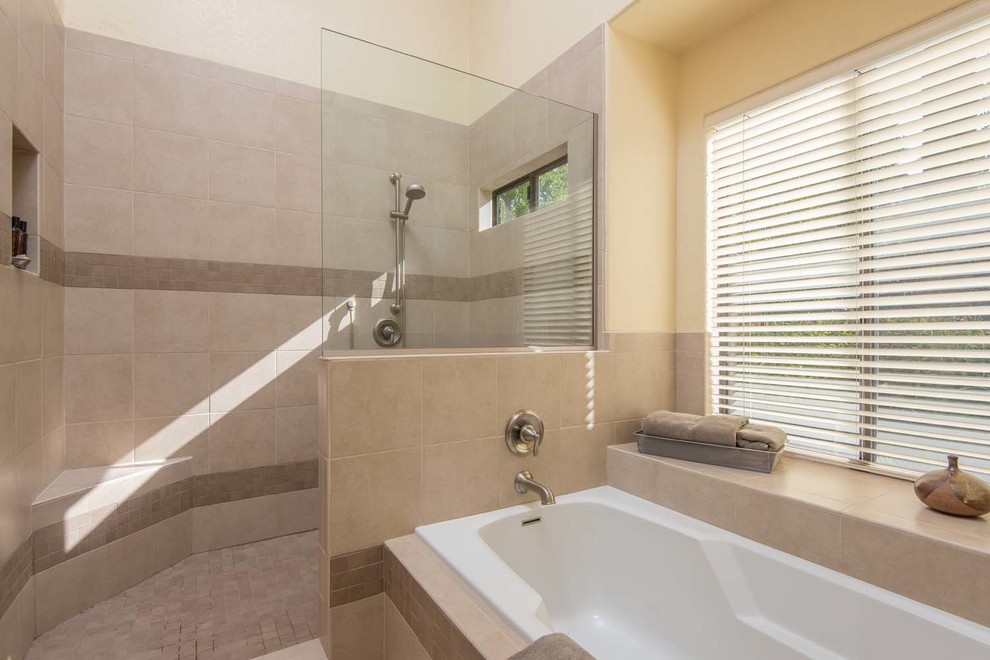 Large contemporary ensuite bathroom in San Diego with a submerged sink, raised-panel cabinets, beige cabinets, granite worktops, a built-in bath, a corner shower, a one-piece toilet, beige tiles, porcelain tiles, yellow walls and porcelain flooring.