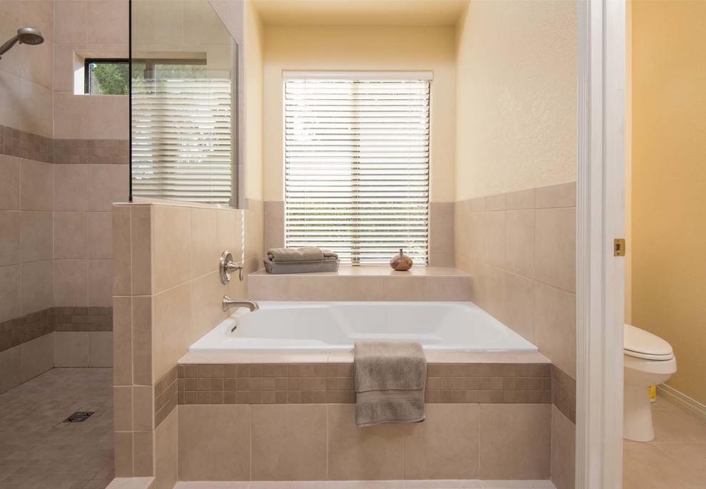Großes Modernes Badezimmer En Suite mit Unterbauwaschbecken, profilierten Schrankfronten, beigen Schränken, Granit-Waschbecken/Waschtisch, Einbaubadewanne, Eckdusche, Toilette mit Aufsatzspülkasten, beigen Fliesen, Porzellanfliesen, gelber Wandfarbe und Porzellan-Bodenfliesen in San Diego