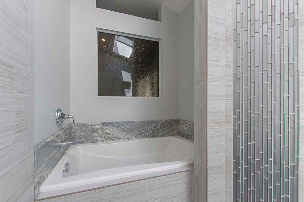 This is an example of a large modern ensuite bathroom in San Diego with recessed-panel cabinets, grey cabinets, an alcove bath, a walk-in shower, a two-piece toilet, grey tiles, porcelain tiles, grey walls, porcelain flooring, a built-in sink, quartz worktops, grey floors and a hinged door.