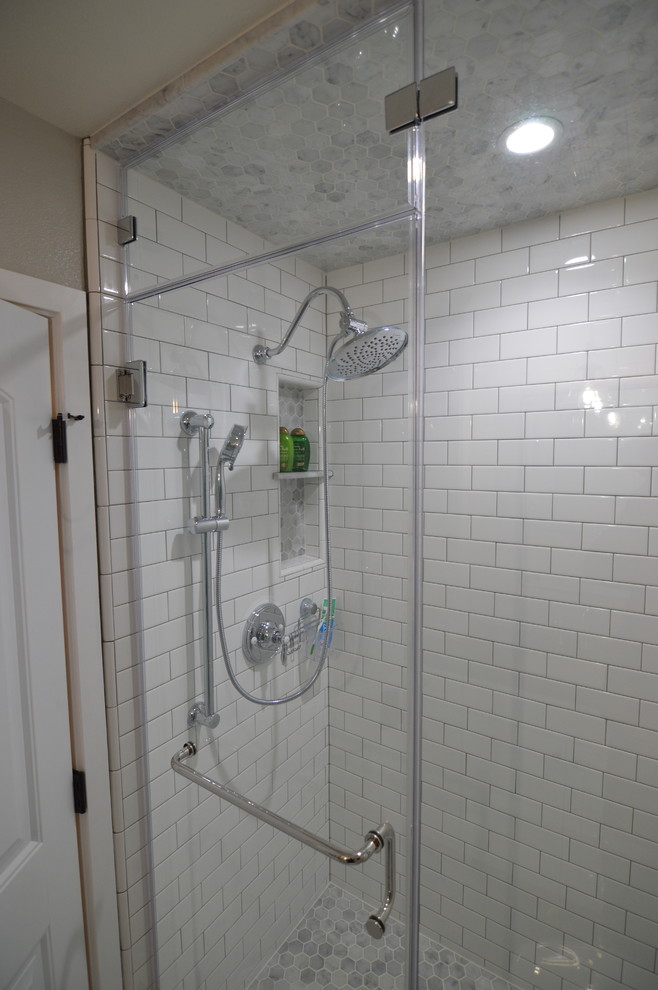 This is an example of a medium sized country shower room bathroom in Los Angeles with shaker cabinets, white cabinets, an alcove shower, a two-piece toilet, white tiles, metro tiles, beige walls, marble flooring, a submerged sink and soapstone worktops.