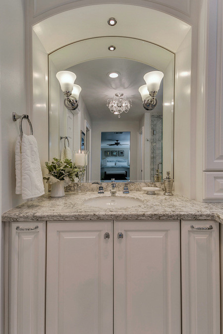 Inspiration for a large traditional ensuite bathroom in Los Angeles with a submerged sink, freestanding cabinets, white cabinets, engineered stone worktops, a corner shower, a one-piece toilet, white tiles, stone tiles, grey walls and marble flooring.