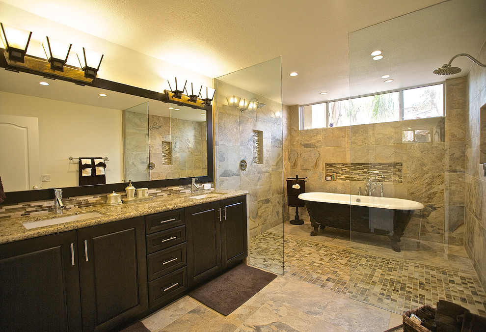 Bathroom - traditional beige tile bathroom idea in Other with an undermount sink, raised-panel cabinets and dark wood cabinets