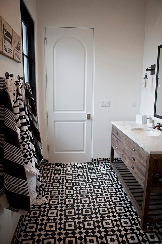 Mid-sized transitional black and white tile and cement tile ceramic tile alcove shower photo in San Diego with medium tone wood cabinets, a one-piece toilet, white walls, an undermount sink, marble countertops and furniture-like cabinets