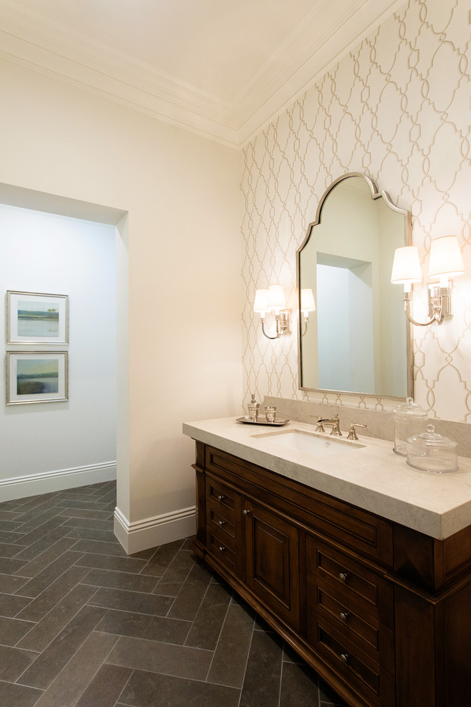 Example of a large transitional 3/4 beige tile and limestone tile limestone floor and brown floor walk-in shower design in San Diego with furniture-like cabinets, brown cabinets, a one-piece toilet, beige walls, an undermount sink and marble countertops
