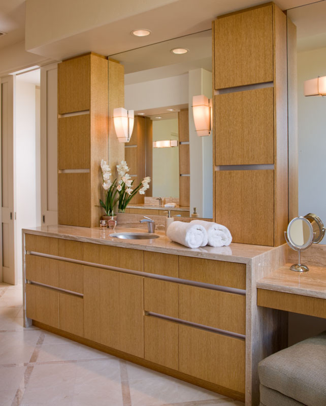Inspiration for a mid-sized contemporary limestone floor bathroom remodel in San Diego with flat-panel cabinets, light wood cabinets, beige walls and an undermount sink
