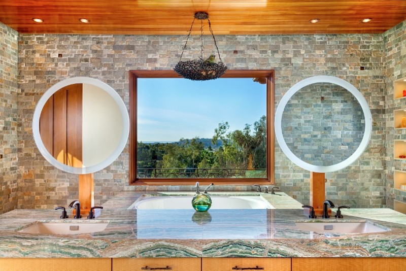Example of a large tuscan master gray tile and stone slab bathroom design in San Diego with an undermount sink, furniture-like cabinets, light wood cabinets, marble countertops and an undermount tub