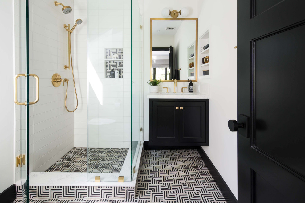 Inspiration for a transitional 3/4 white tile multicolored floor corner shower remodel in Los Angeles with recessed-panel cabinets, black cabinets, white walls, an undermount sink, a hinged shower door and white countertops
