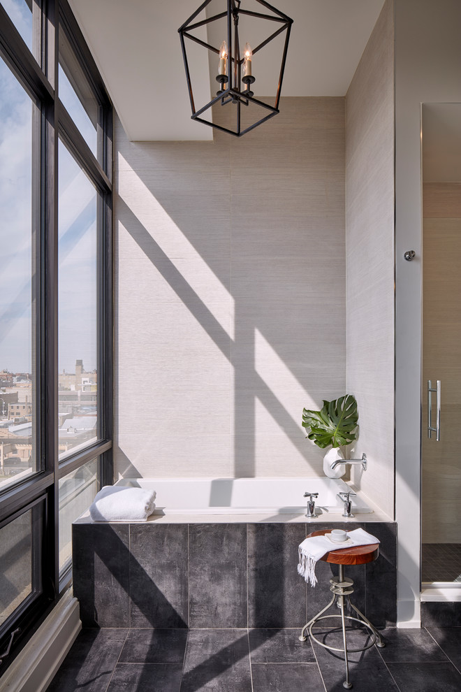 This is an example of a large contemporary ensuite bathroom in Chicago with a walk-in shower, a one-piece toilet, porcelain tiles, porcelain flooring, a submerged sink, black floors, a hinged door, a built-in bath, grey tiles and white walls.