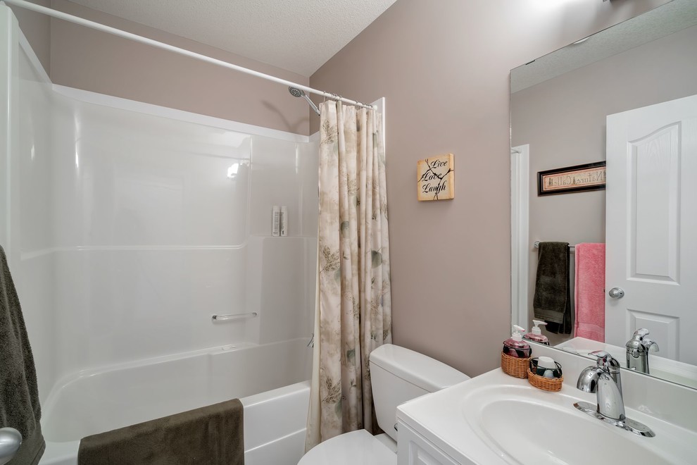 Esempio di una stanza da bagno per bambini minimalista di medie dimensioni con ante in stile shaker, ante bianche, vasca/doccia, WC monopezzo, pareti beige e lavabo da incasso