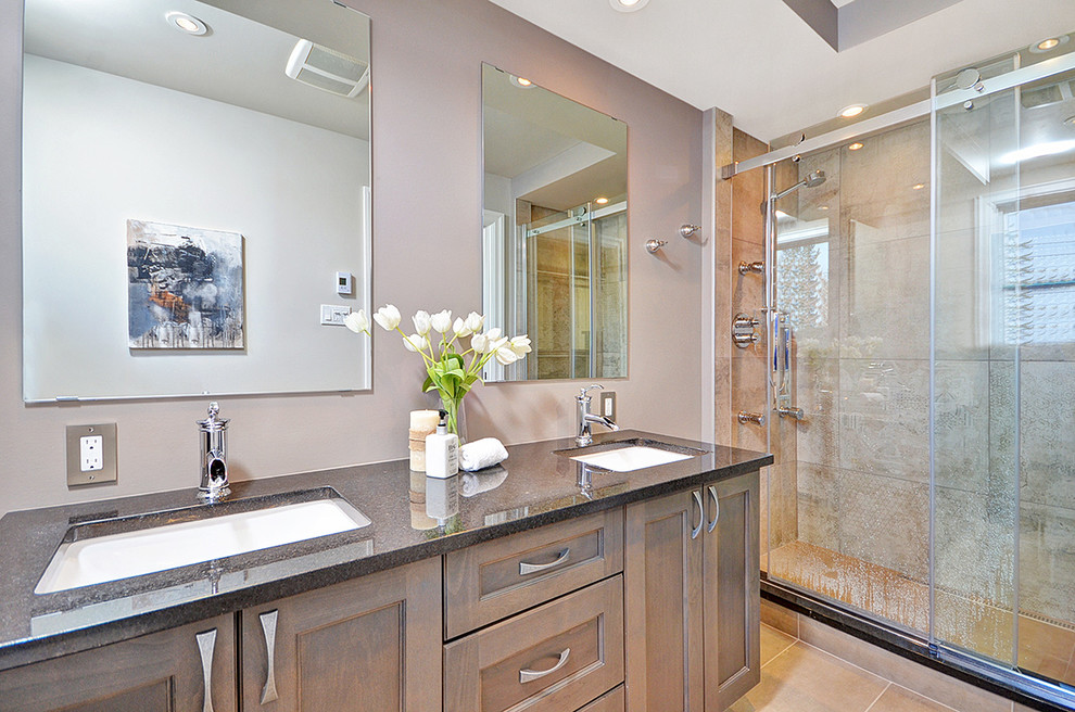 Photo of a medium sized contemporary ensuite bathroom in Ottawa with a one-piece toilet, beige tiles, ceramic tiles, grey walls, vinyl flooring, recessed-panel cabinets, medium wood cabinets, an alcove shower, a submerged sink, granite worktops, beige floors and a sliding door.