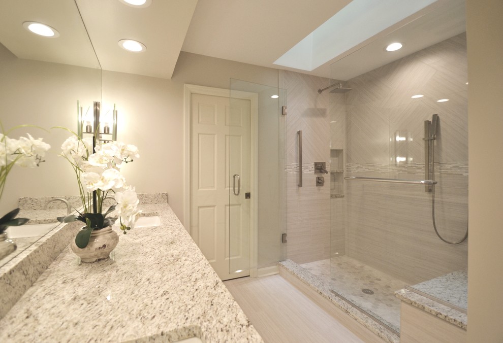 Corner shower - mid-sized modern master beige tile corner shower idea in Indianapolis with recessed-panel cabinets, white cabinets, beige walls and an undermount sink