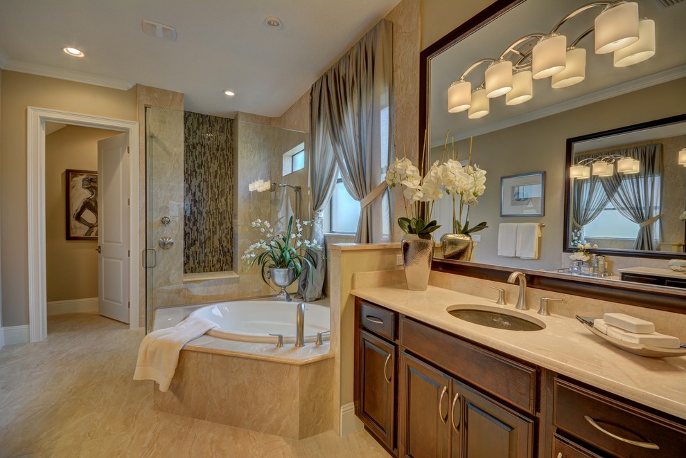 Design ideas for a large traditional ensuite bathroom in Orlando with recessed-panel cabinets, dark wood cabinets, a corner bath, a one-piece toilet, brown tiles, beige tiles, multi-coloured tiles, beige walls, a submerged sink, granite worktops, a corner shower, porcelain tiles, porcelain flooring, beige floors and a hinged door.