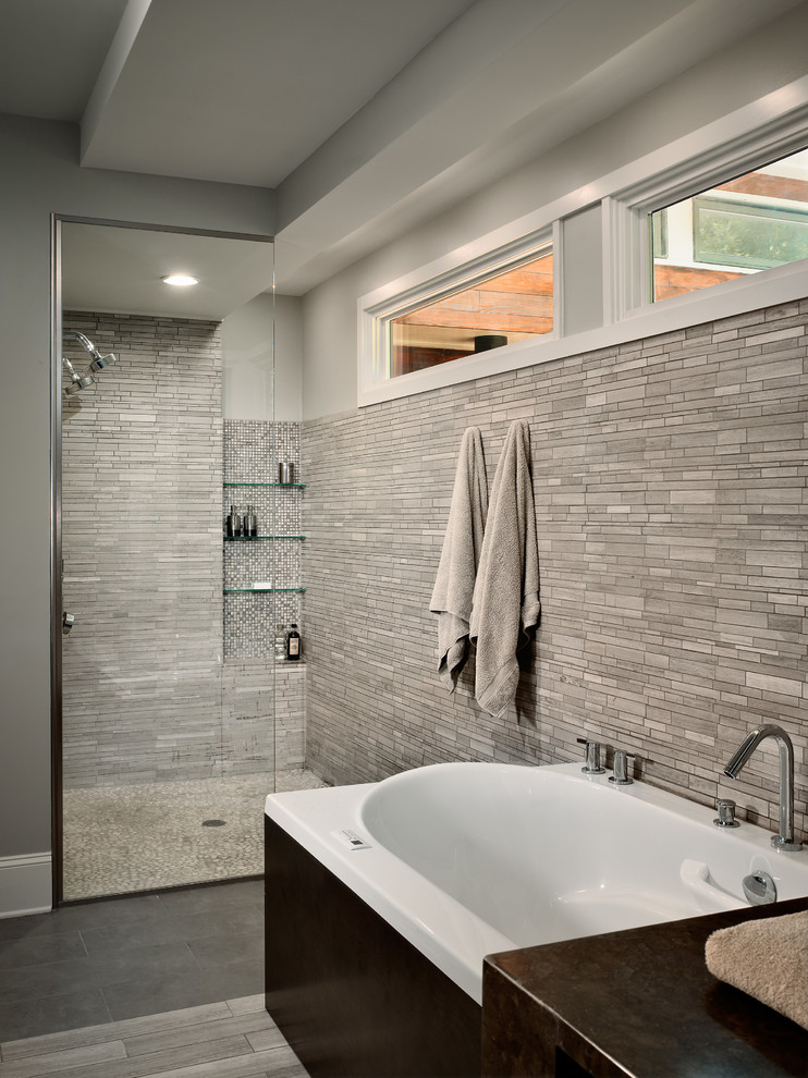 This is an example of a medium sized modern ensuite bathroom in Atlanta with flat-panel cabinets, grey cabinets, a built-in bath, a built-in shower, a one-piece toilet, grey tiles, porcelain tiles, grey walls, porcelain flooring, a submerged sink and granite worktops.