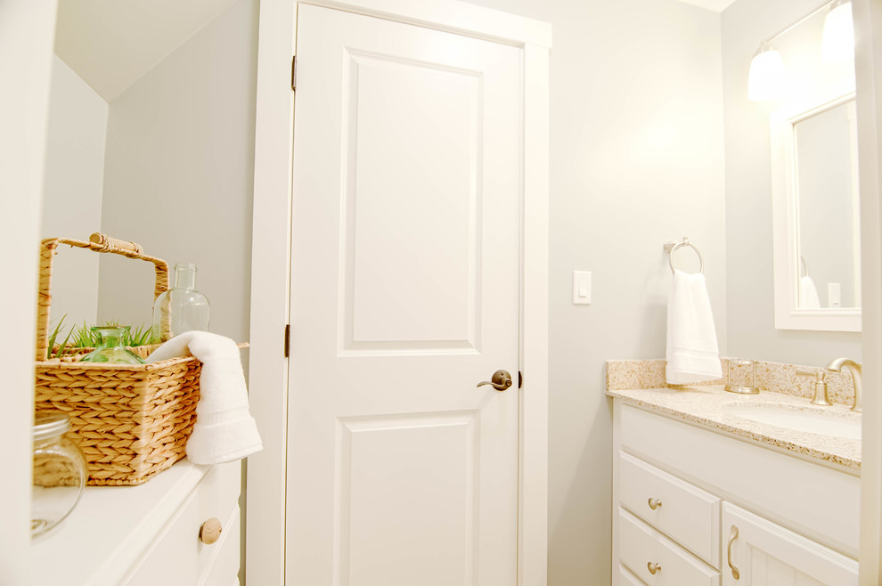 Example of a mid-sized arts and crafts kids' ceramic tile and beige floor bathroom design in Portland Maine with beaded inset cabinets, white cabinets, a two-piece toilet, blue walls, an undermount sink and granite countertops