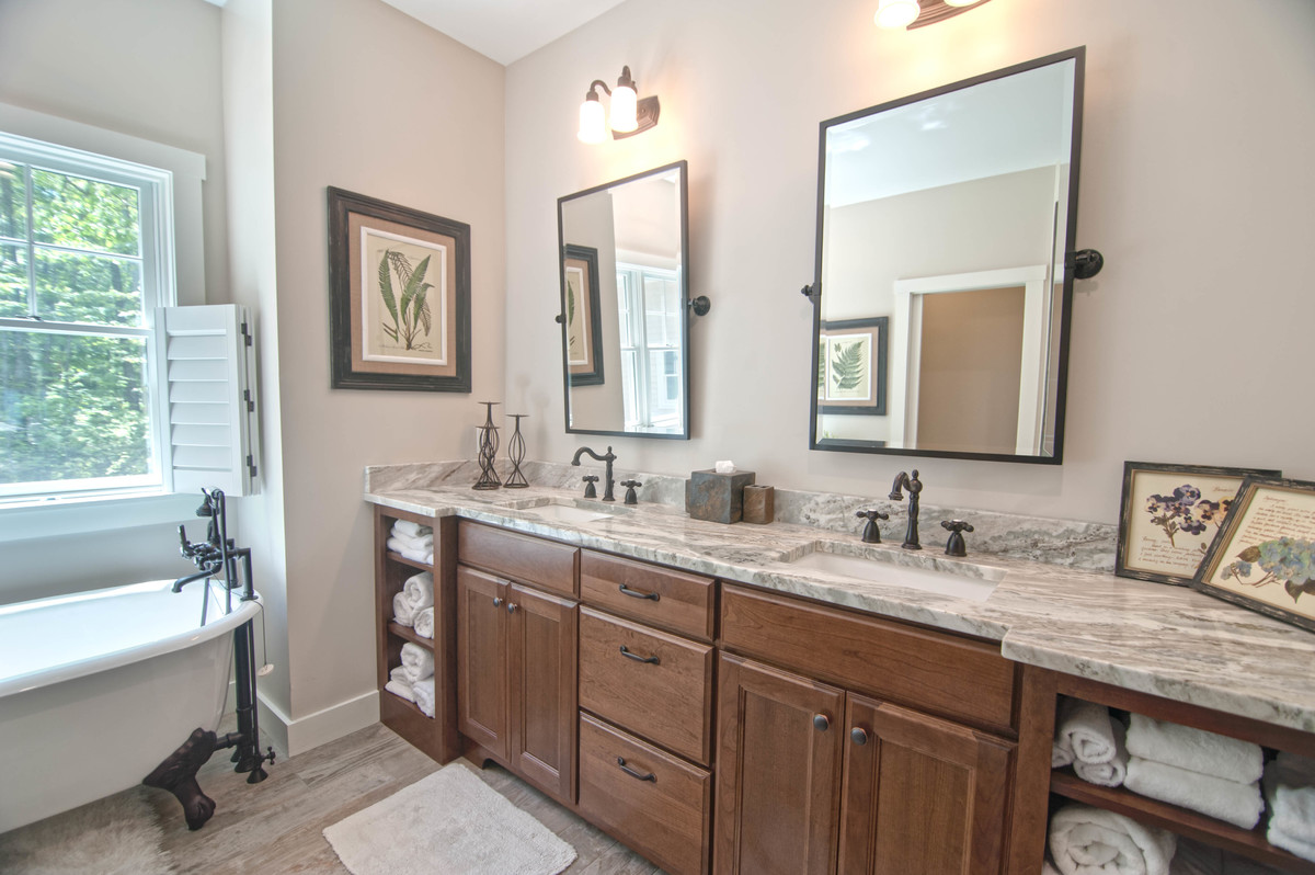 Medium sized traditional ensuite bathroom in Portland Maine with recessed-panel cabinets, dark wood cabinets, a claw-foot bath, a corner shower, a one-piece toilet, multi-coloured tiles, slate tiles, grey walls, ceramic flooring, a submerged sink, granite worktops, beige floors and a hinged door.