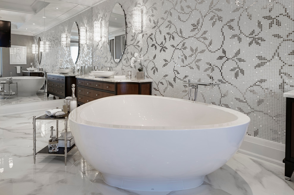 Bild på ett mycket stort vintage en-suite badrum, med ett fristående handfat, möbel-liknande, skåp i mellenmörkt trä, marmorbänkskiva, ett fristående badkar, en kantlös dusch, en toalettstol med hel cisternkåpa, vit kakel, porslinskakel, flerfärgade väggar och marmorgolv