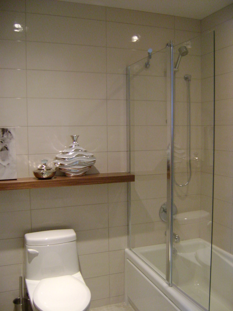 Inredning av ett exotiskt litet badrum med dusch, med luckor med profilerade fronter, granitbänkskiva, beige kakel, keramikplattor, ett badkar i en alkov, en dusch/badkar-kombination, en toalettstol med separat cisternkåpa, ett piedestal handfat, beige väggar och klinkergolv i keramik