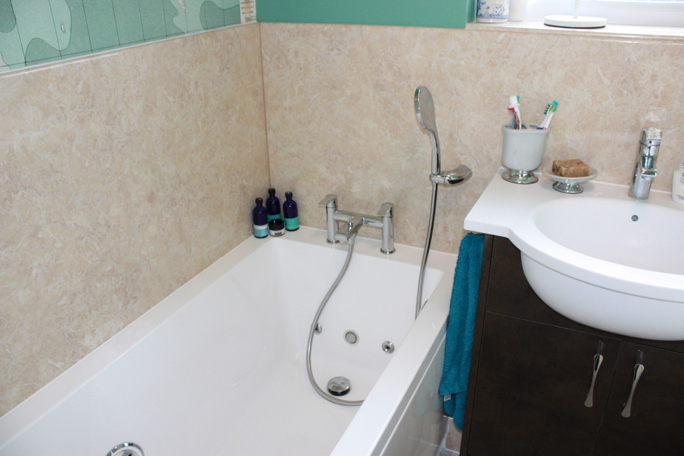 Medium sized contemporary family bathroom in Kent with flat-panel cabinets, brown cabinets, a hot tub, a built-in shower, a one-piece toilet, brown tiles, ceramic tiles, brown walls, vinyl flooring, a built-in sink, solid surface worktops and brown floors.