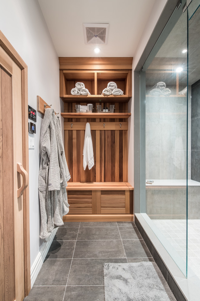 Photo of a medium sized traditional sauna bathroom in Toronto with louvered cabinets and light wood cabinets.