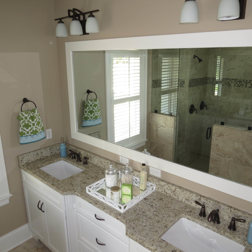This is an example of a large rural ensuite bathroom in Atlanta with shaker cabinets, white cabinets, an alcove shower, a one-piece toilet, beige walls, a submerged sink and granite worktops.