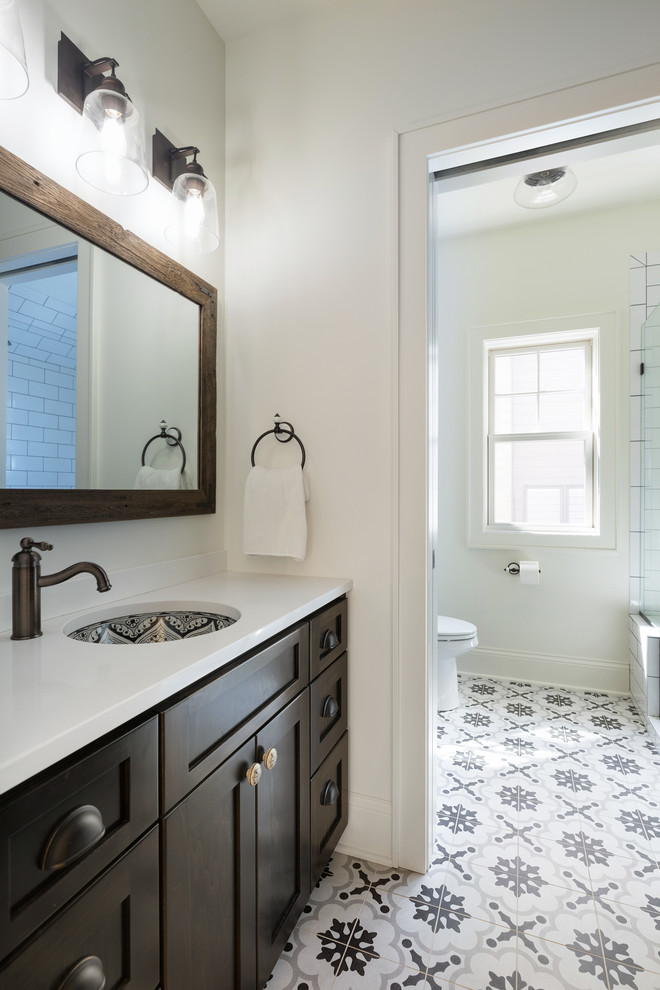 Mid-sized beach style 3/4 white tile and porcelain tile cement tile floor and gray floor alcove shower photo in Minneapolis with shaker cabinets, dark wood cabinets, a two-piece toilet, white walls, an undermount sink, concrete countertops and a hinged shower door