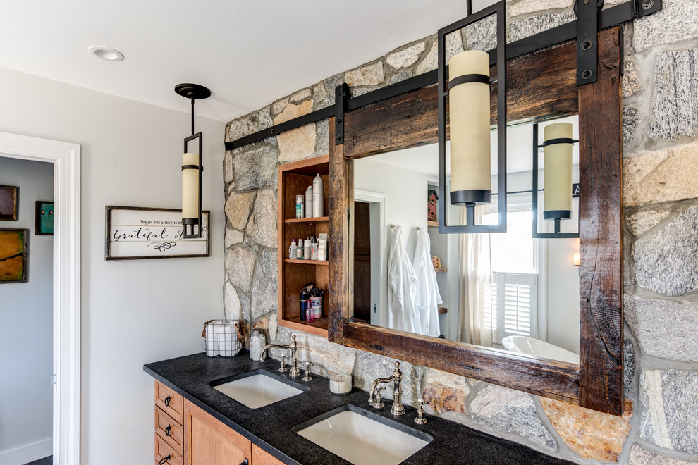 Example of a large mountain style master gray tile and cement tile cement tile floor and gray floor bathroom design in New York with shaker cabinets, light wood cabinets, a one-piece toilet, gray walls, an undermount sink and granite countertops