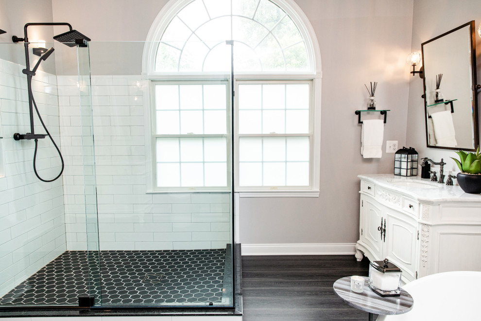 Design ideas for a traditional ensuite bathroom in Baltimore with freestanding cabinets, a corner shower, a one-piece toilet, a sliding door and a vaulted ceiling.