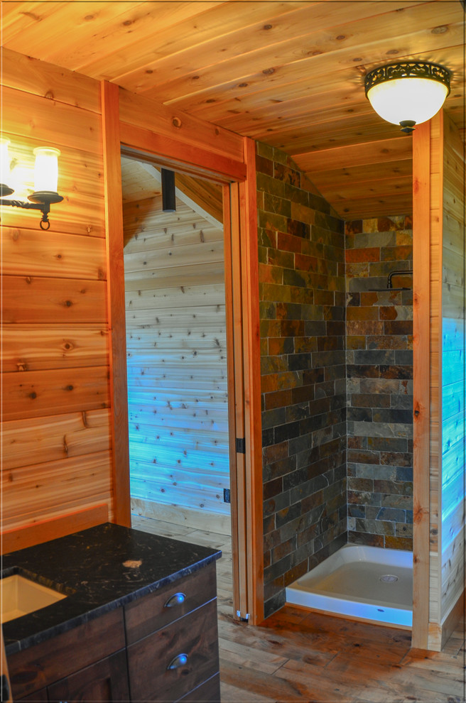 Mid-sized mountain style master multicolored tile and slate tile medium tone wood floor alcove shower photo in Calgary with flat-panel cabinets, dark wood cabinets, an undermount sink and granite countertops
