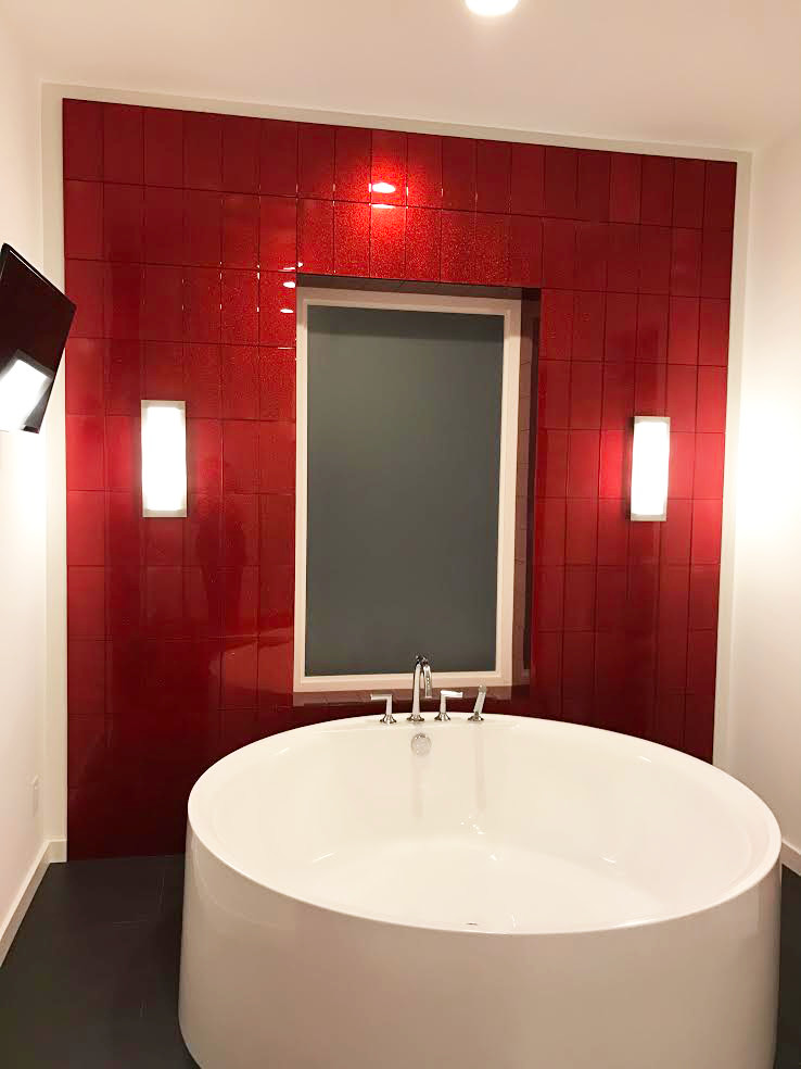 На фото: главная ванная комната среднего размера в стиле модернизм с гидромассажной ванной, красной плиткой, стеклянной плиткой и белыми стенами