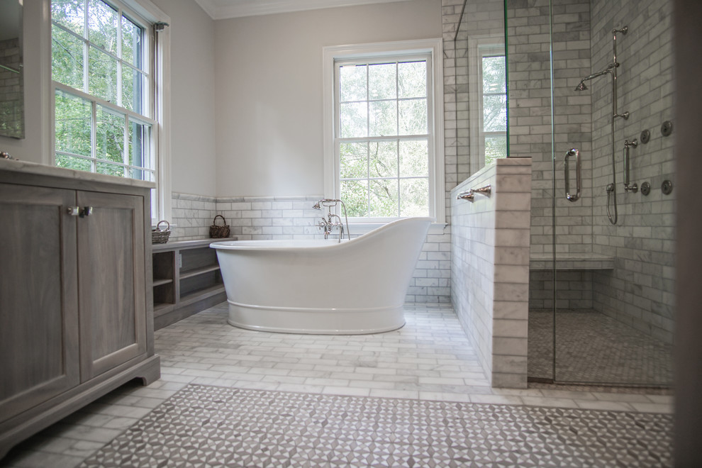 Design ideas for a large classic ensuite bathroom in Atlanta with shaker cabinets, grey cabinets, a freestanding bath, a built-in shower, a one-piece toilet, grey tiles, marble tiles, white walls, marble flooring, a submerged sink, marble worktops, grey floors, a hinged door and white worktops.