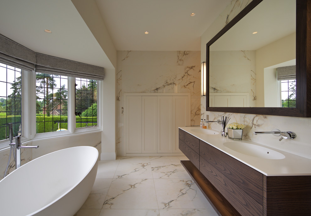 Inspiration for a large traditional ensuite bathroom in Hertfordshire with flat-panel cabinets, dark wood cabinets, a submerged sink, engineered stone worktops and white worktops.