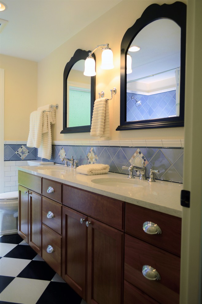 Photo of a medium sized classic ensuite bathroom in Seattle with recessed-panel cabinets, dark wood cabinets, an alcove bath, a shower/bath combination, grey tiles, white tiles, porcelain tiles, yellow walls, porcelain flooring, a submerged sink, quartz worktops, multi-coloured floors and a shower curtain.