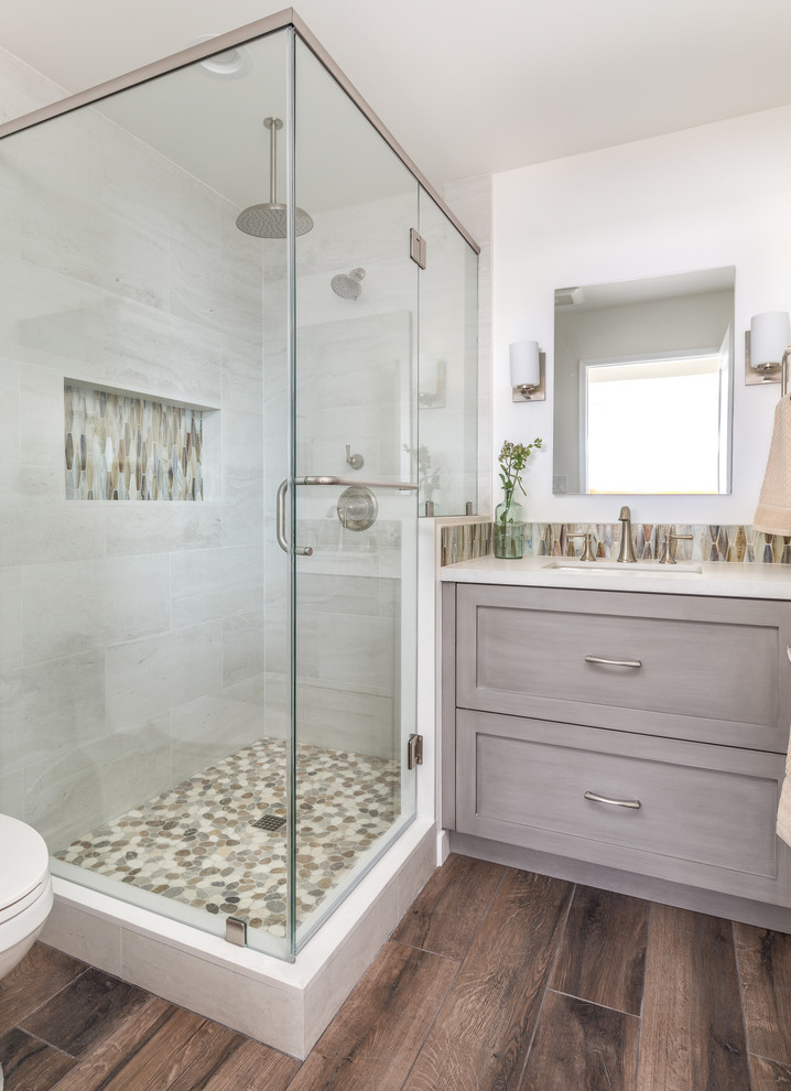 Inspiration for a mid-sized brown tile and porcelain tile porcelain tile and brown floor corner shower remodel in Los Angeles with shaker cabinets, gray cabinets, an undermount sink, concrete countertops, a hinged shower door and white countertops