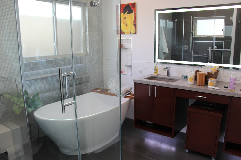 Example of a mid-sized trendy master slate floor bathroom design in Los Angeles with furniture-like cabinets, dark wood cabinets, white walls, an undermount sink and solid surface countertops