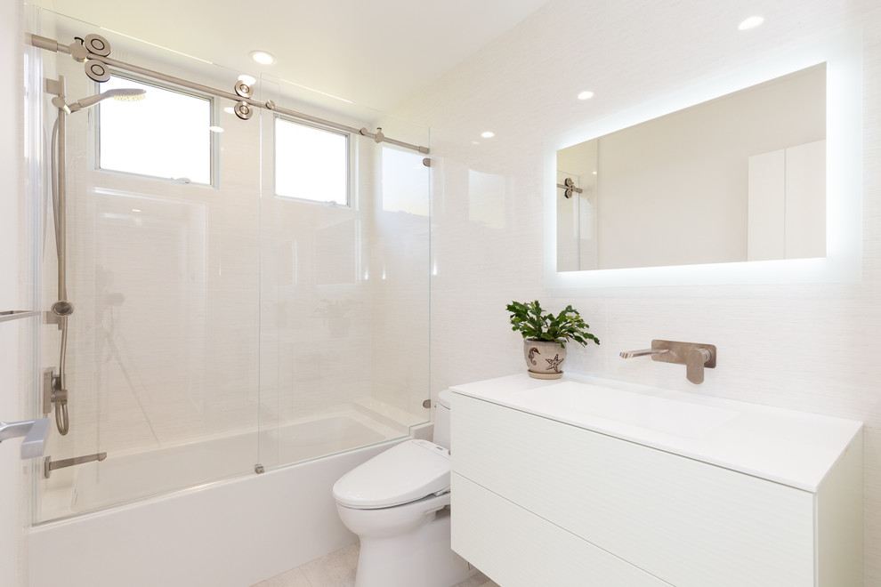 Example of a small minimalist kids' white tile cement tile floor and beige floor bathroom design in San Francisco with flat-panel cabinets, white cabinets, white walls, an integrated sink and white countertops