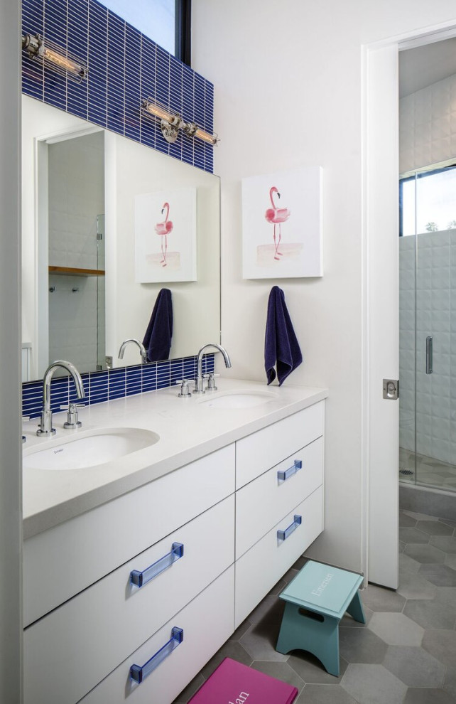 Example of an urban white tile gray floor and double-sink alcove shower design in San Diego with flat-panel cabinets, white cabinets, white walls, an undermount sink, a hinged shower door, white countertops and a floating vanity