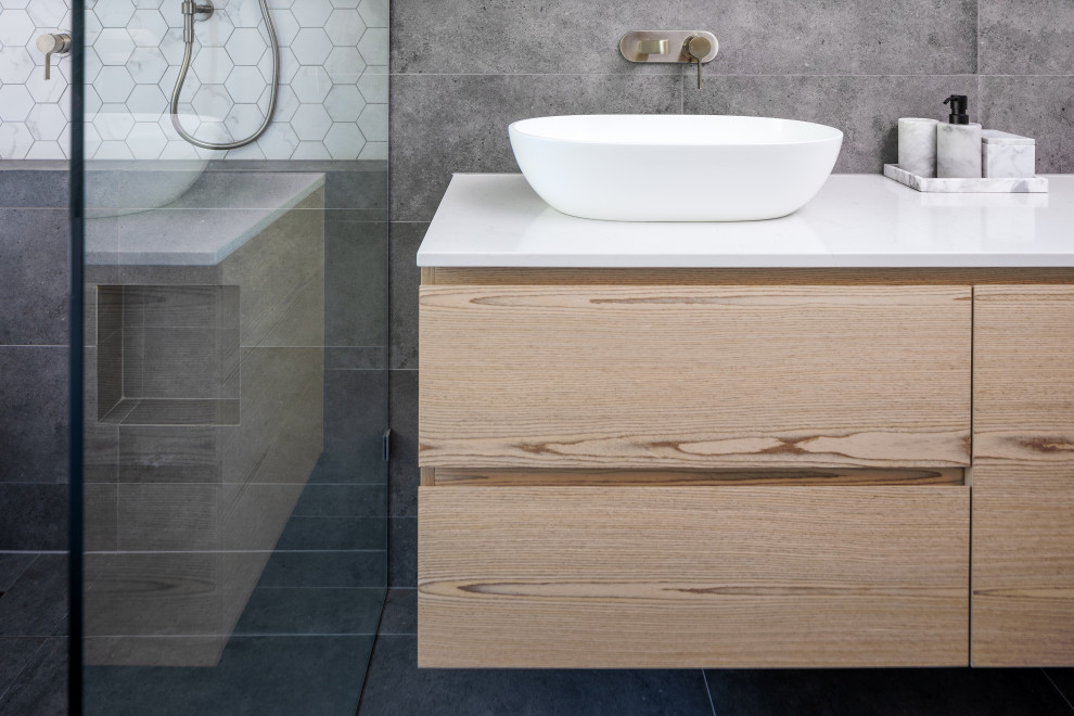 Foto på ett mellanstort funkis vit badrum, med släta luckor, skåp i ljust trä, ett fristående badkar, en öppen dusch, bänkskiva i kvarts och med dusch som är öppen