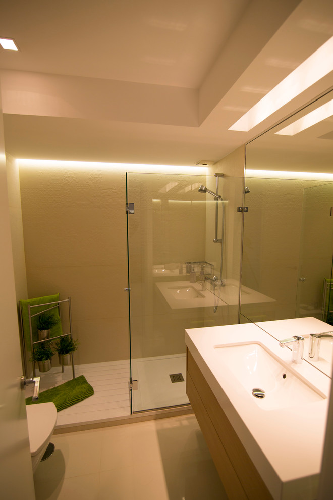 Design ideas for a medium sized contemporary shower room bathroom in Madrid with flat-panel cabinets, medium wood cabinets, an alcove shower, a two-piece toilet, white walls, ceramic flooring and an integrated sink.
