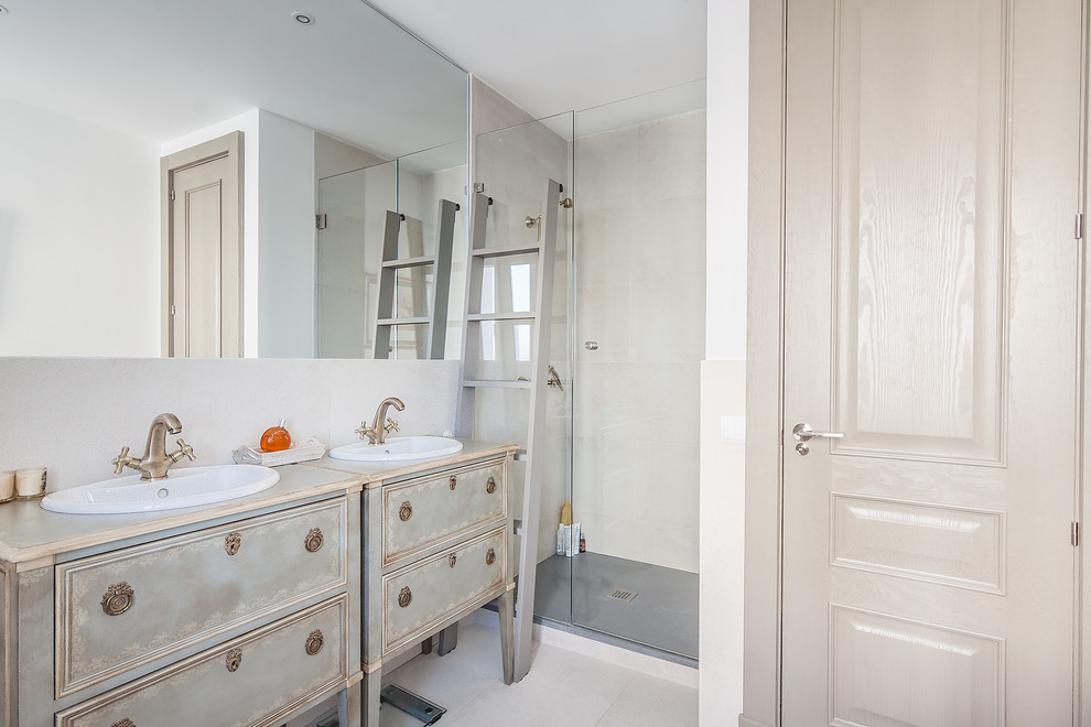 Inspiration for a small transitional master ceramic tile corner shower remodel in Madrid with furniture-like cabinets, distressed cabinets, beige walls and an undermount sink