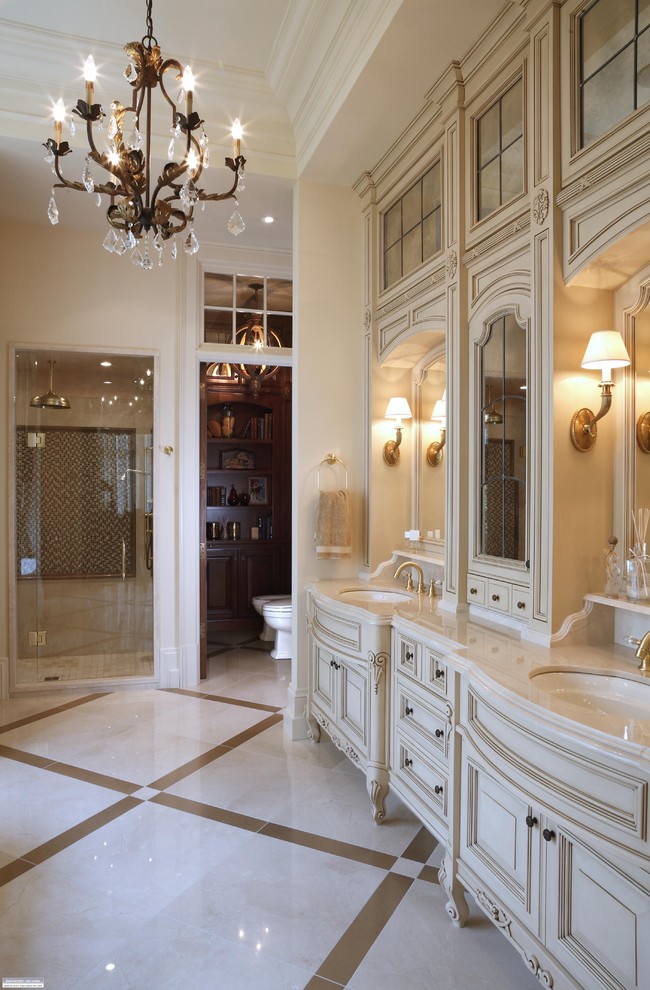 Inspiration for a victorian beige floor alcove shower remodel in Burlington with raised-panel cabinets